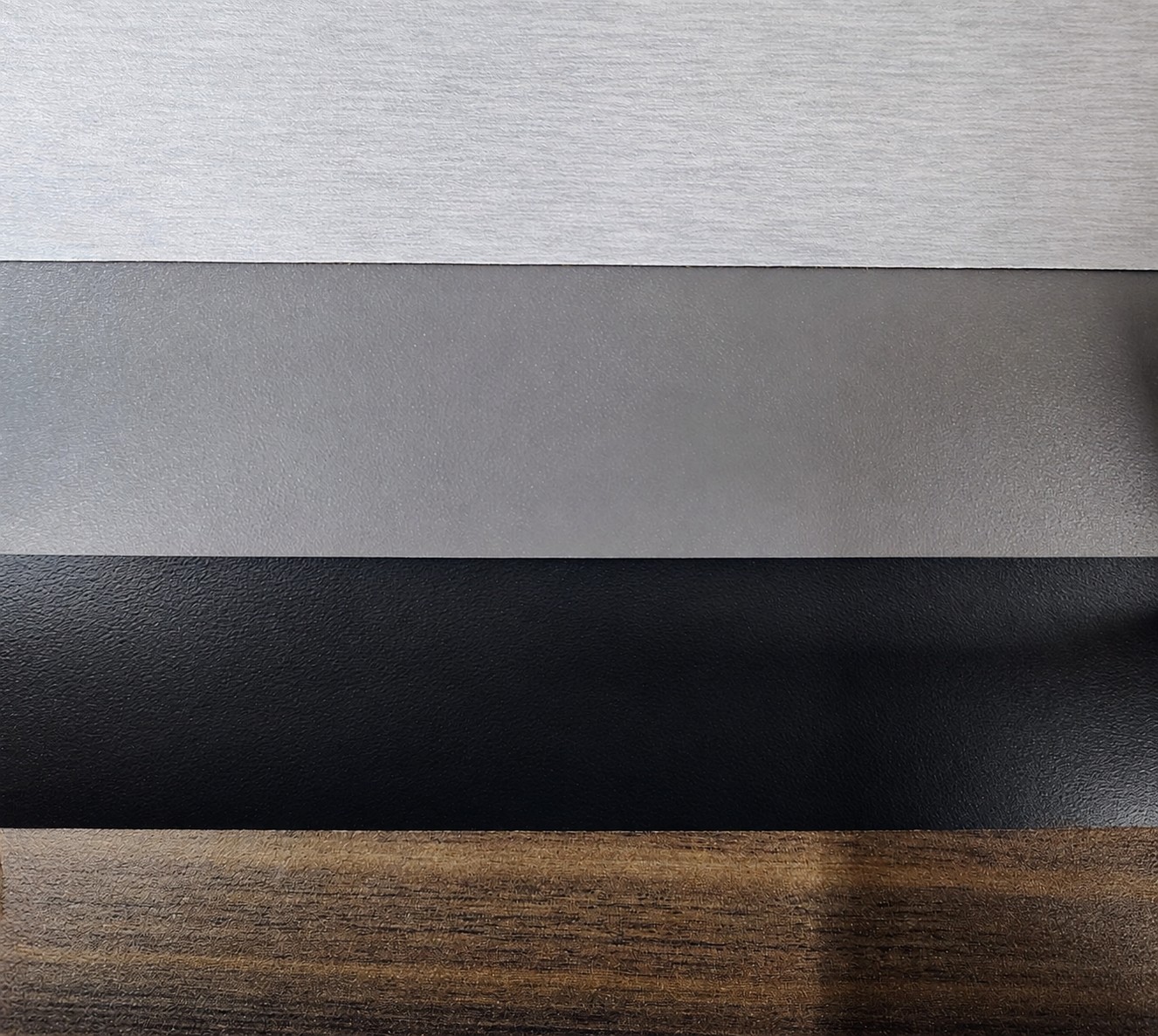Textured laminate samples in white, gray, black, and woodgrain finishes
